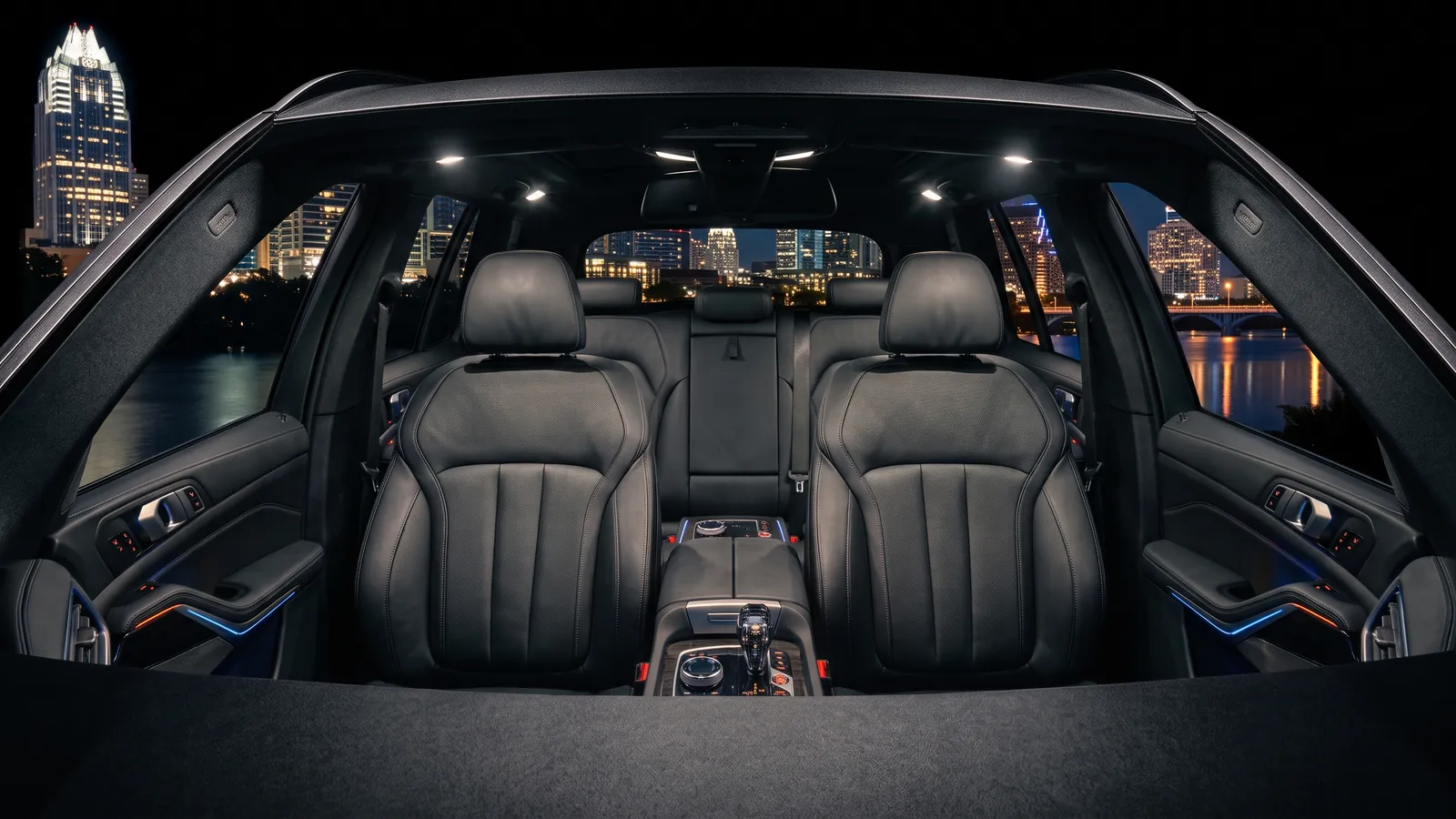 Carpool Critics mobile studio inside a parked car overlooking the Austin, Texas night skyline